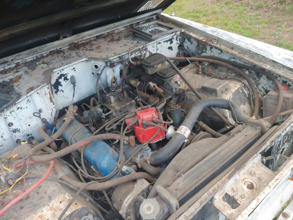 Engine bay of a 1977 Ford Bronco, showing the V8 engine and radiator