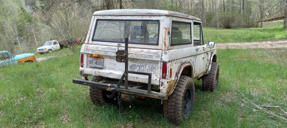 White 1977 Ford Bronco rear view with spare tire mount