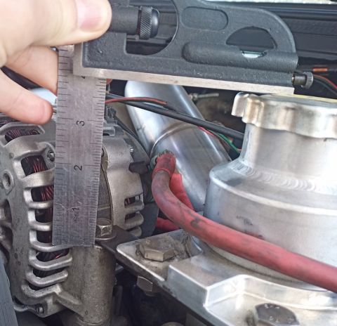 2001 Ford Excursion - Close-up of an engine component being measured with a caliper tool.