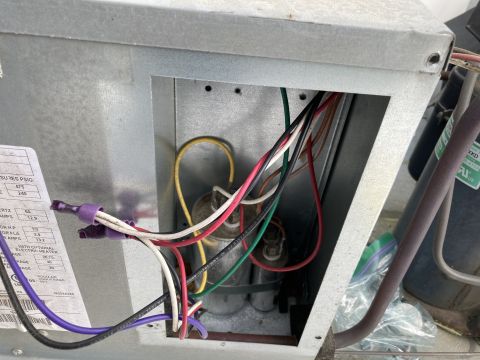2015 Ford F-550 - Close-up view of internal wiring and components within an air conditioning unit, including capacitors and electrical connections.