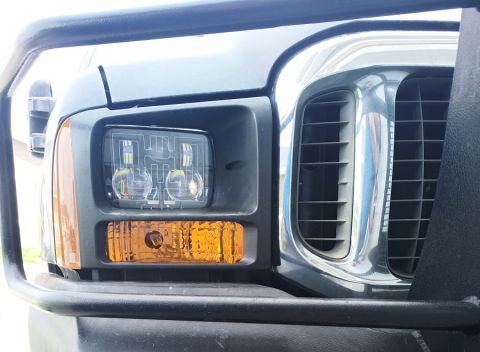 2001 Ford Excursion - The front corner of a Ford Super Duty truck, its distinctive square headlight and chrome grille.