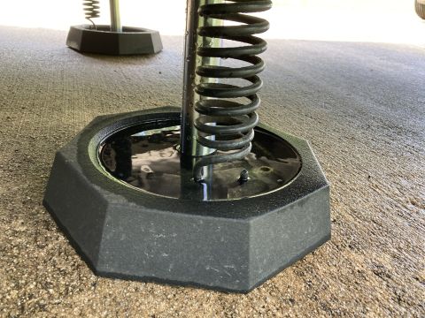 2015 Ford F-550 - A close-up view of a leveler jack base, showing the hexagonal plastic and a metal spring mechanism.