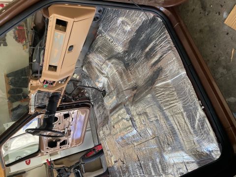 1984 Ford Bronco - Vehicle interior undergoing sound deadening installation, dashboard removed.