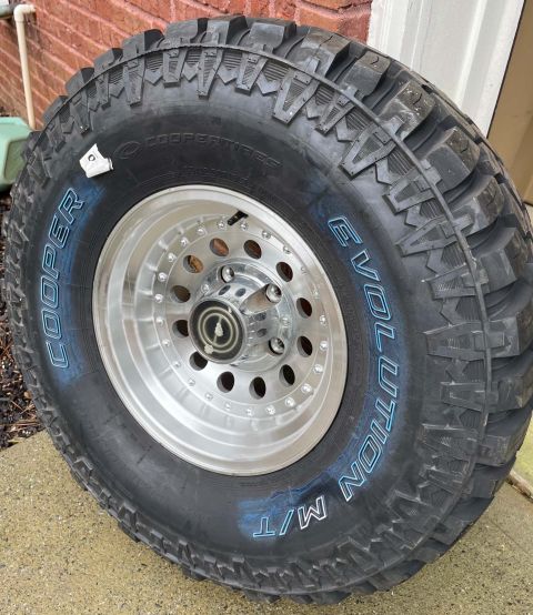 1984 Ford Bronco - A single off-road tire and wheel assembly is shown, with visible branding and tread detail.