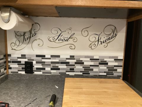 2015 Ford F-550 - Interior backsplash features mosaic tile and decorative decals reading 'Good Times Good Food Good Friends'.