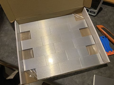 2015 Ford F-550 - Box contains multiple brushed aluminum backsplash tiles, some still covered in plastic.