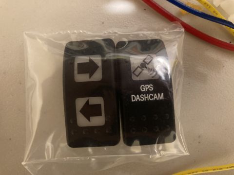 2015 Ford F-550 - A close-up view of two switch covers, one labeled for GPS Dashcam functionality.