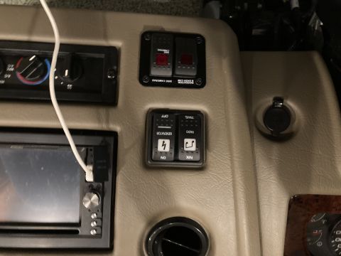 2015 Ford F-550 - Interior view of dashboard controls including switches for generator and radio, and a car stereo unit.