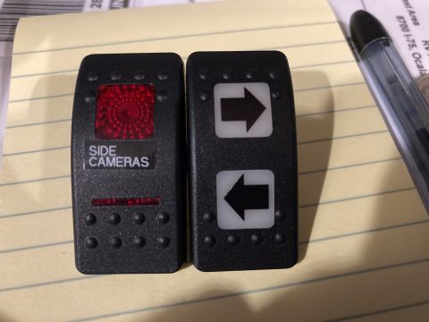 2015 Ford F-550 - Aftermarket switches for vehicle cameras and directional control are shown on a lined surface.
