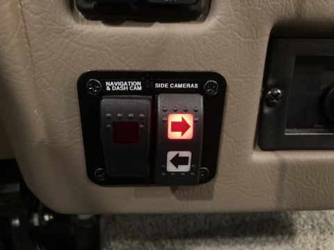 2015 Ford F-550 - Close-up of a vehicle's interior control panel buttons for navigation, dash cam, and side cameras.