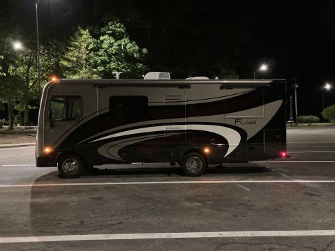 2015 Ford F-550 - A motorhome is parked outdoors at night, illuminated by streetlights.