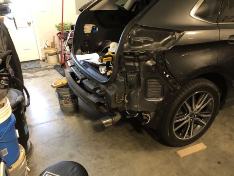 2019 Ford Everest - Rear bumper removed, exposing the tow receiver and internal components of a dark SUV.