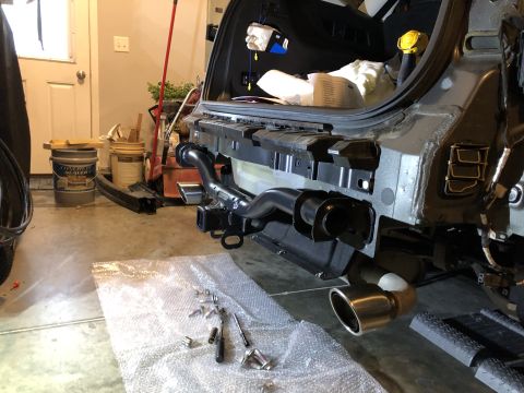 2019 Ford Everest - A tow hitch receiver and exhaust pipe are visible on the rear of a vehicle, with tools laid out on bubble wrap.