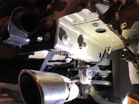 2019 Ford Everest - Underside view of a tow receiver and exhaust pipe, with visible mounting hardware and chassis components.