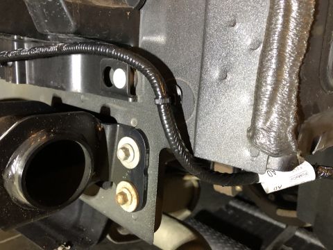 2019 Ford Everest - Detail of a vehicle's tow hitch wiring harness, showing electrical connections and protective sheathing.