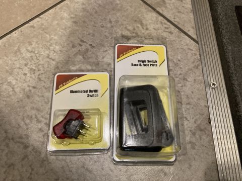 2015 Ford F-550 - Two aftermarket vehicle accessory switches are displayed in their retail packaging.