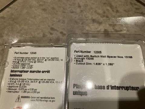 2015 Ford F-550 - Two packages of automotive light switches are shown, with part numbers and specifications printed on them.
