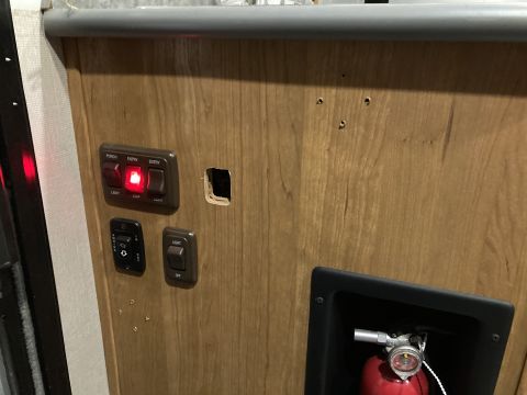 2015 Ford F-550 - Close-up of interior compartment light switches, one illuminated red.