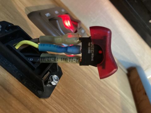 2015 Ford F-550 - Automotive toggle switch with wiring, possibly for compartment lights, showing electrical connections.