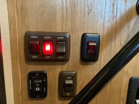 2015 Ford F-550 - A panel of interior light switches is visible on a wood-grain surface.