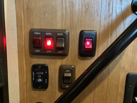 2015 Ford F-550 - Close-up of various interior light switches, including controls for porch, entry, step, and awning functions.