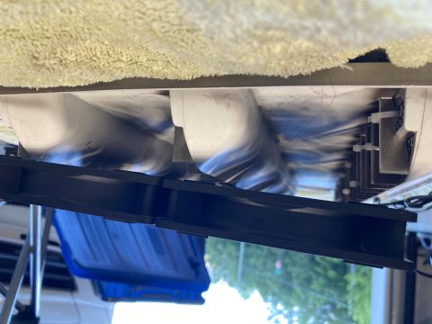 2015 Ford F-550 - Close-up of two vent fans, likely for a refrigerator, mounted on a bracket with a fuzzy blanket overhead.