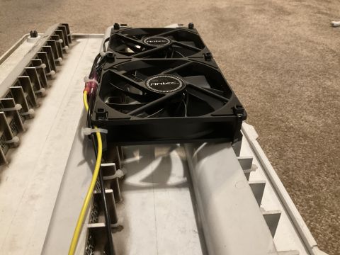 2015 Ford F-550 - Two computer fans are mounted on a white housing with metal grating, with yellow wires visible.