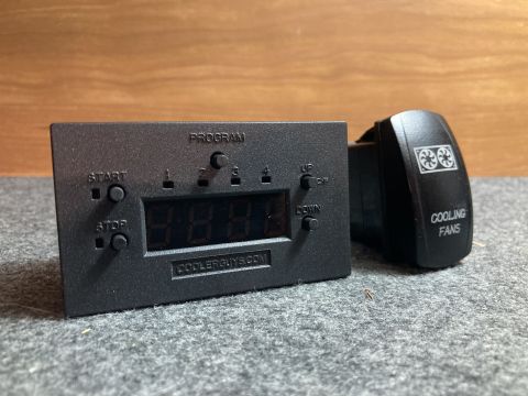 2015 Ford F-550 - A digital controller and a cooling fan switch are shown against a textured background.