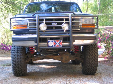 1995 Ford Bronco - Frontal view of a modified Ford Bronco with a bull bar and off-road tires.