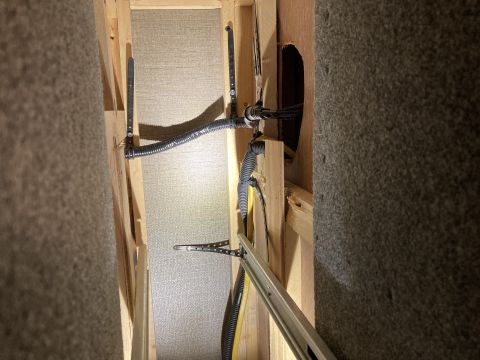 2015 Ford F-550 - Close-up view of the internal construction and wiring within an RV, revealing the underlying framework and insulation materials.