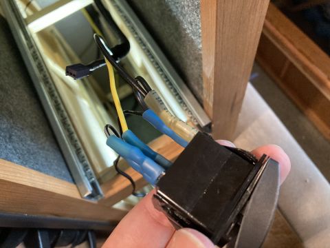 2015 Ford F-550 - A hand holds a black electrical switch with wires attached, with 'SUPERMOTORS' text in the lower right corner.