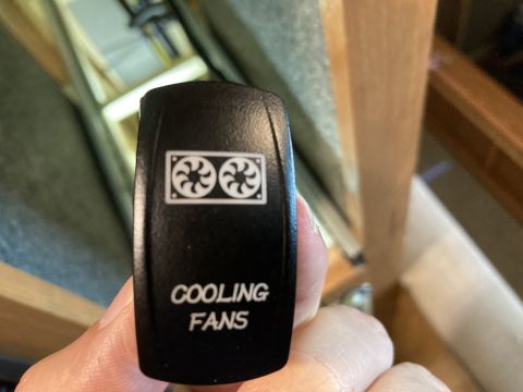 2015 Ford F-550 - A close-up of a black switch labeled 'COOLING FANS' with an icon of two fans.