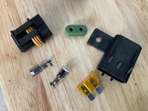 2015 Ford F-550 - Various electrical components, including connectors and a fuse, are laid out on a wooden surface.