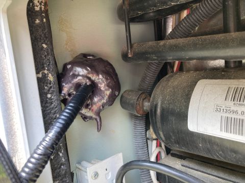 2015 Ford F-550 - Melted sealant around wire conduit near compressor unit.