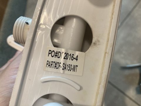 2015 Ford F-550 - A white plastic part is shown up close, with a sticker indicating its part number and a purchase order date.