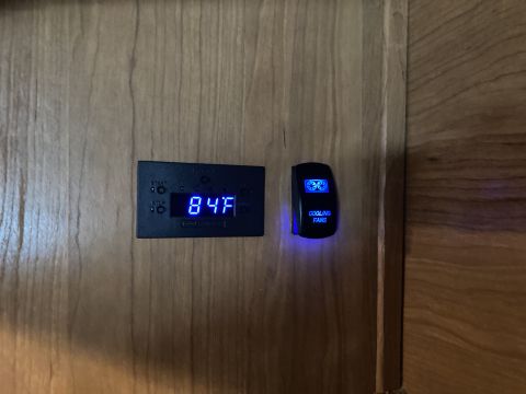 2015 Ford F-550 - A digital temperature gauge displays 84 degrees Fahrenheit next to a switch labeled 'COOLING FANS'.
