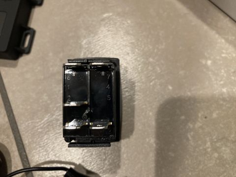 2015 Ford F-550 - Close-up of a black electrical relay switch with visible numbered terminals.
