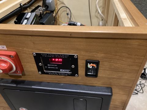 2015 Ford F-550 - Close-up of an electrical panel displaying voltage and a switch, likely from an RV or camper.