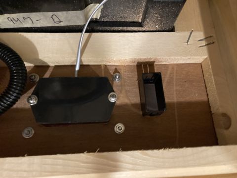 2015 Ford F-550 - Close-up of a TPMS sensor and its wiring, installed within a wooden compartment.