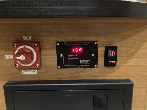 2015 Ford F-550 - Close-up of vehicle interior electrical controls, including a TPMS switch and an inverter panel.