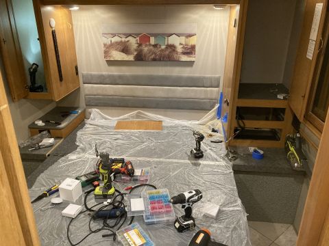 2015 Ford F-550 - Tools and electrical supplies are laid out on the bed of an RV, suggesting ongoing maintenance or modification work.