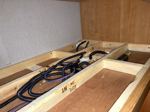 2015 Ford F-550 - Close-up of exposed wooden framing and electrical wiring, likely part of an RV or camper interior.