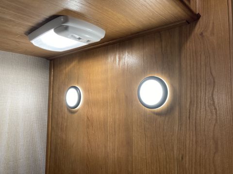 2015 Ford F-550 - Interior view showing ceiling and wall lights illuminating a wood-paneled area.