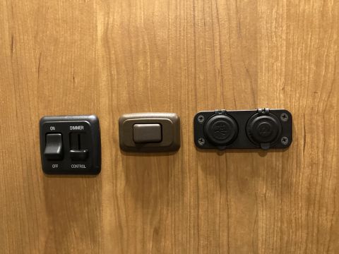 2015 Ford F-550 - Close-up of an interior control panel showing various switches and power outlets.