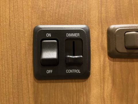 2015 Ford F-550 - A close-up shows an interior light dimmer switch with an ON/OFF toggle and a slider for brightness control.