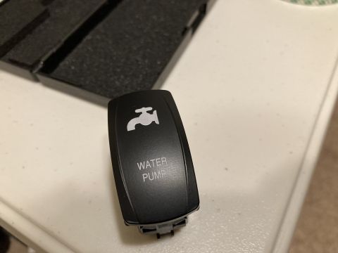 2015 Ford F-550 - A close-up of a water pump switch, likely for a vehicle accessory.
