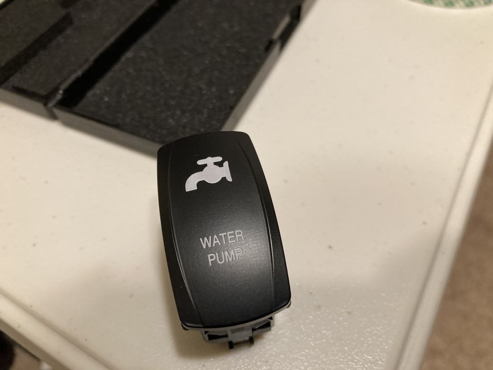 Black switch with a white water faucet icon and 'WATER PUMP' text