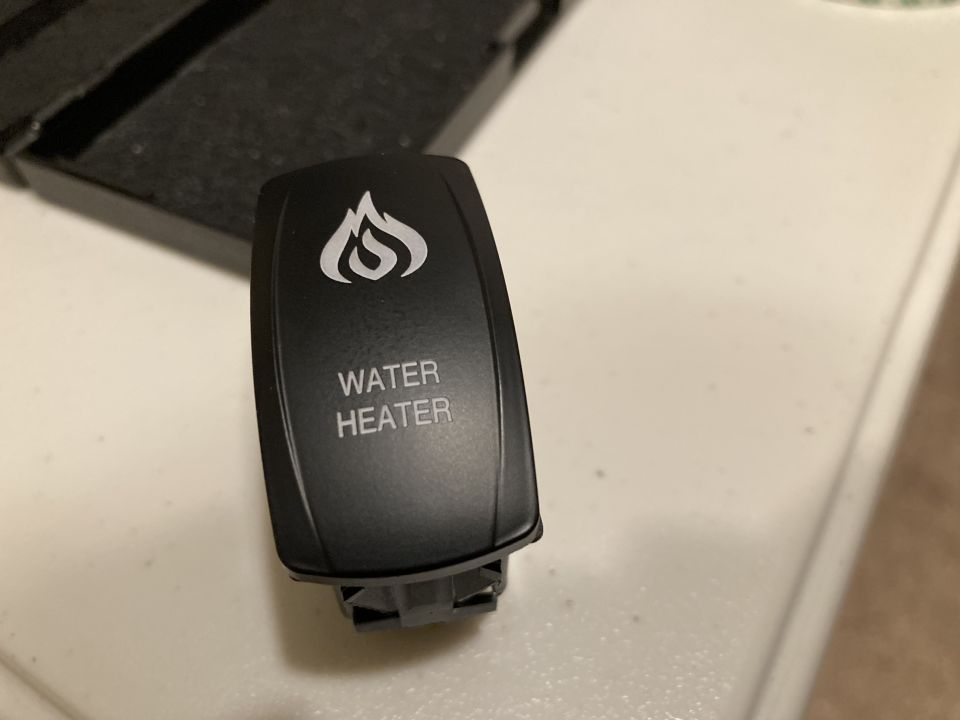 Black water heater switch with flame icon and text