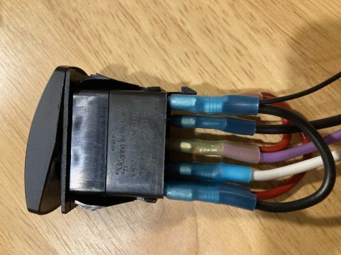 2015 Ford F-550 - A close-up view of an automotive switch with its wiring harness, showing various colored wires attached to terminals.