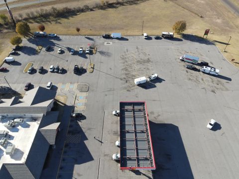2015 Ford F-550 - An aerial perspective captures a busy parking lot filled with various vehicles and a large building.